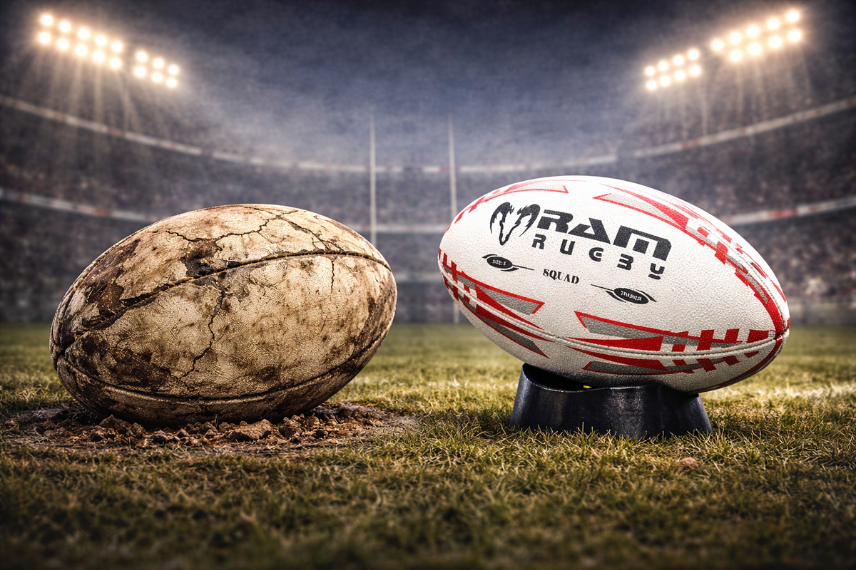 Worn rugby ball with scuffed panels next to a newer ball
