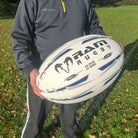 Bright blue Ram Rugby Giant 66cm Super Jumbo rugby ball with 3D grip, extra-large fun ball for schools and clubs.