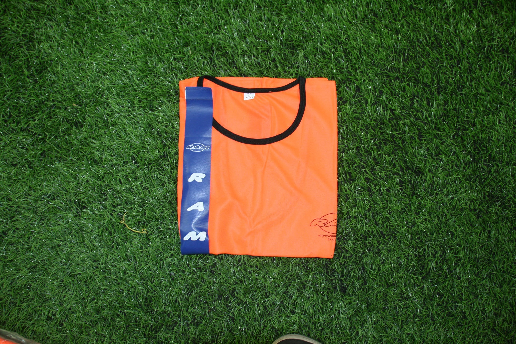 Set of 10 fluorescent orange youth mesh training bibs with blue PVC tags by Ram Rugby for tag rugby practice