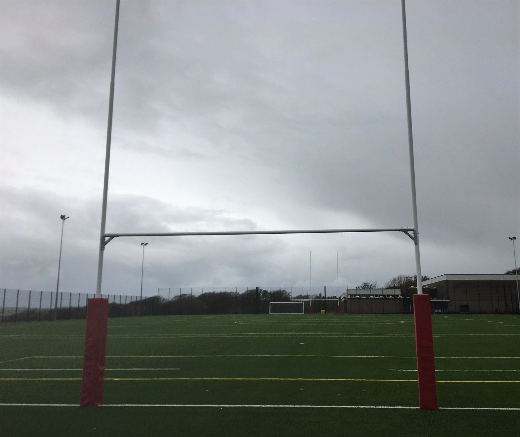 Ram Rugby 11m aluminium hinged rugby goal posts with white crossbar support and two-piece upright design for sports fields