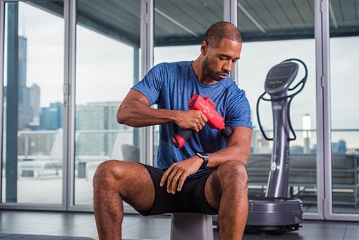 Power Plate Roller vibrating muscle massager in black and gray, portable device for muscle recovery and relief therapy