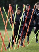 Ram Rugby Standard Training Poles set featuring 6 yellow and 6 orange PVC agility poles with metal spikes for rugby drills